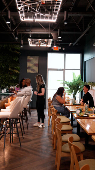 Guests at tables and high-tops in the dining room