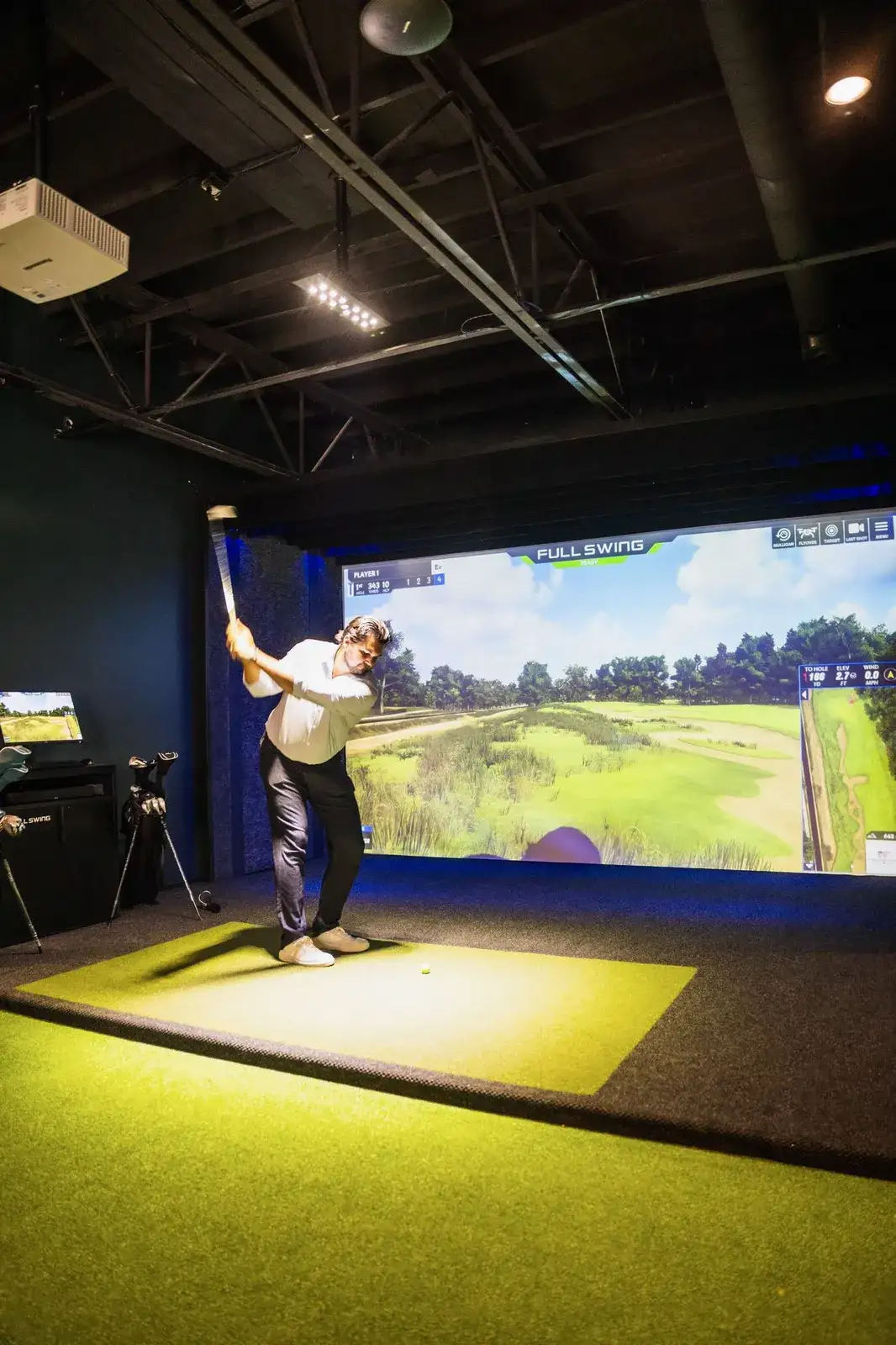 The private Full Swing golf simulator bay